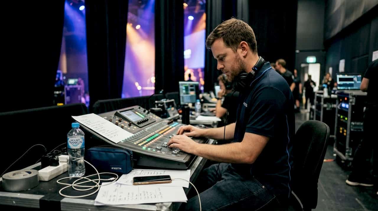 AV technician managing control desk backstage